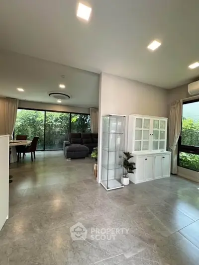 Spacious modern living room with large windows and garden view