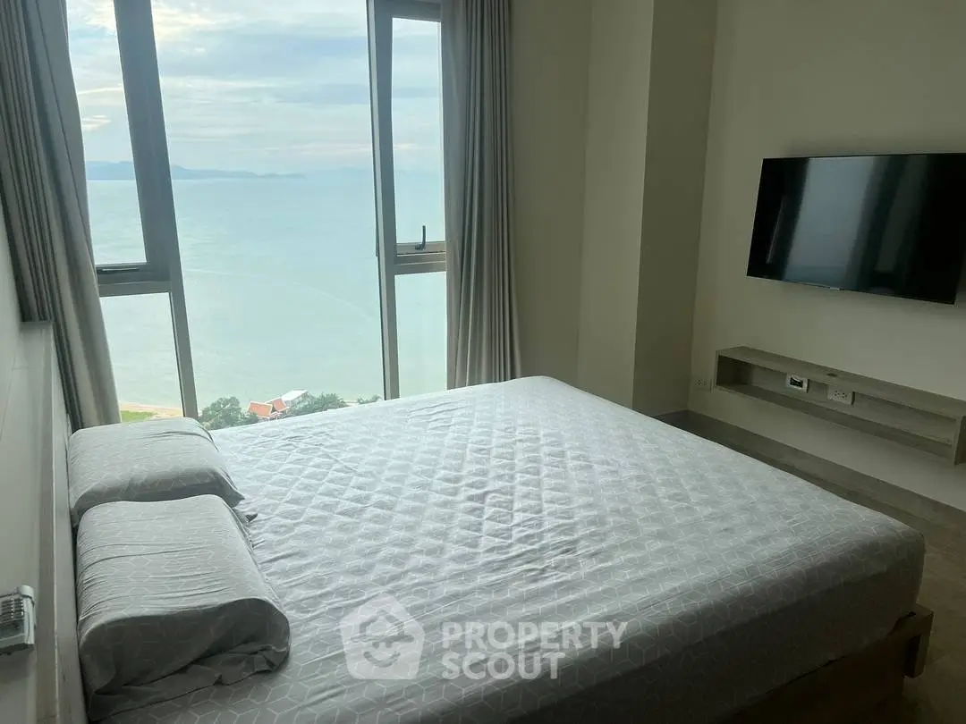 Luxurious bedroom with stunning ocean view and modern amenities.