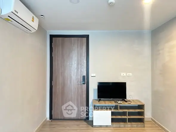 Modern apartment interior with TV stand and air conditioning unit