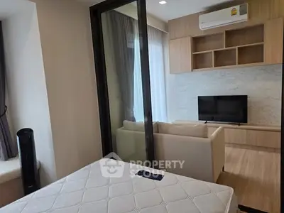 Modern apartment with cozy living room and bedroom separation, featuring sleek design and natural light.