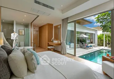 Luxurious bedroom with pool view in modern villa, featuring elegant decor and spacious layout.