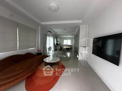 Spacious modern living room with sleek furniture and open layout, perfect for contemporary living.