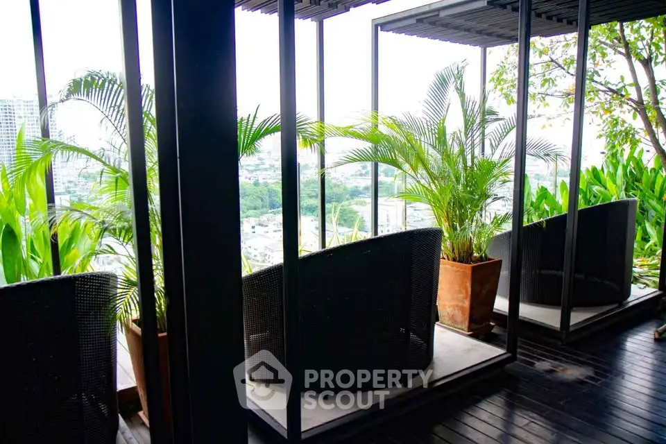 Stunning rooftop terrace with lush greenery and panoramic city views, perfect for relaxation and entertainment.