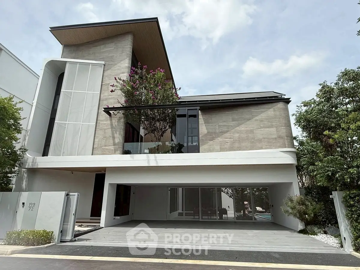 Modern luxury house with sleek design and spacious garage in upscale neighborhood.