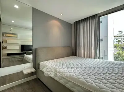 Modern bedroom with large window and stylish decor in urban apartment