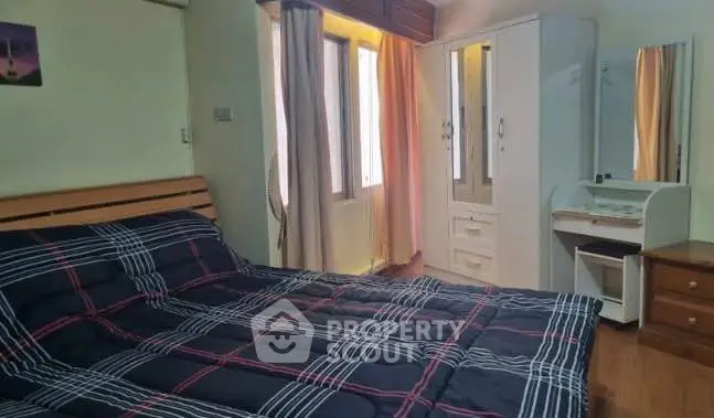 Cozy bedroom with stylish furniture and natural light, perfect for relaxation.