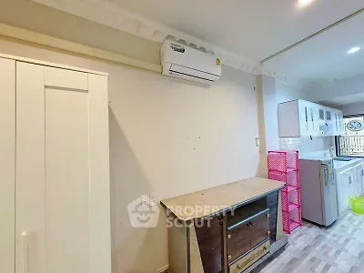 Spacious kitchen with modern appliances and ample storage in a cozy apartment.