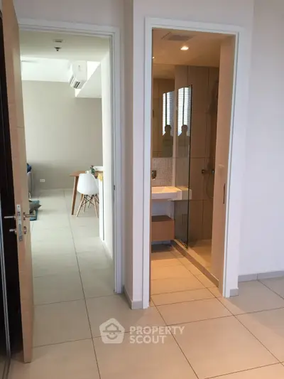 Modern apartment interior with open layout and sleek bathroom design.