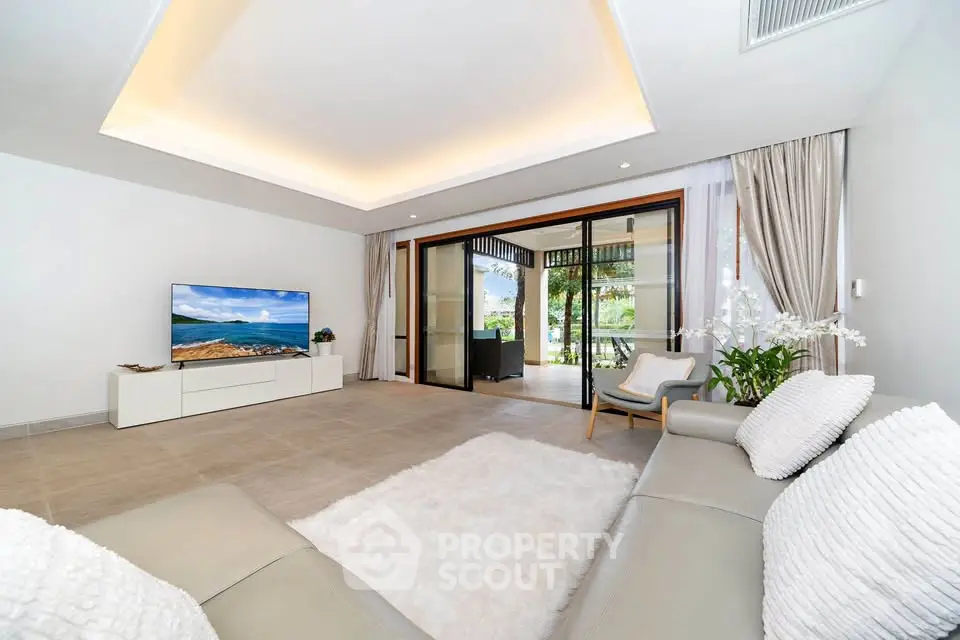 Spacious modern living room with elegant decor and large sliding doors to balcony.