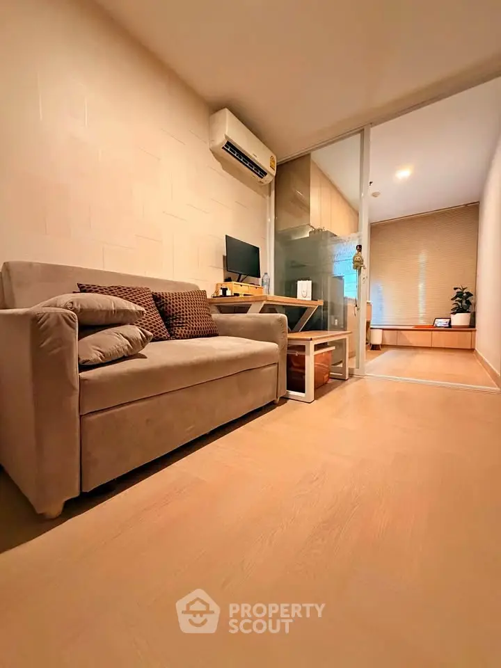 Cozy living room with modern decor and air conditioning in a stylish apartment.