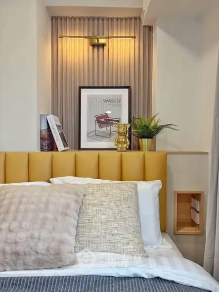 Stylish bedroom with modern decor, plush pillows, and elegant lighting for a cozy ambiance.