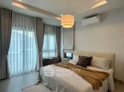 Elegant bedroom with modern decor and large windows for natural light