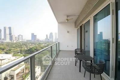 Spacious balcony with stunning city view and modern seating area.
