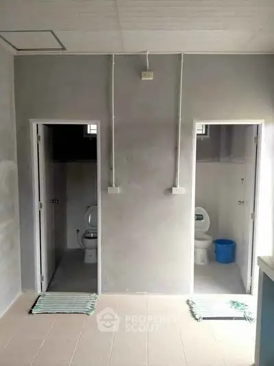Dual bathroom setup with modern fixtures and minimalist design.