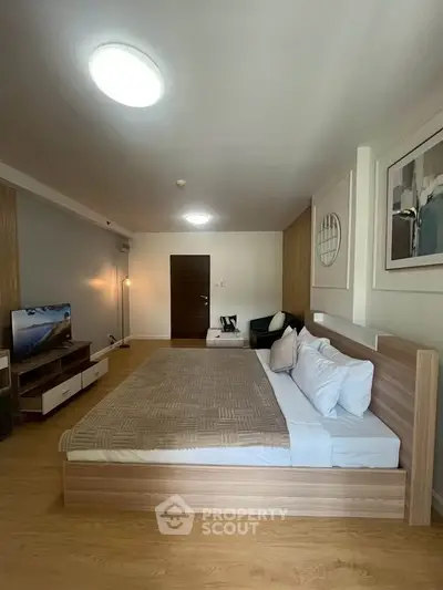 Spacious modern bedroom with stylish decor and cozy ambiance