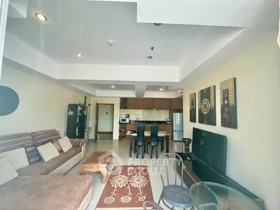 Spacious open-plan living room with modern kitchen and stylish decor
