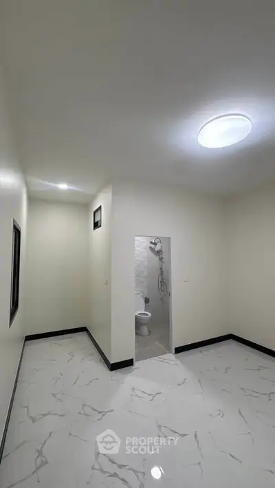 Spacious bathroom with modern fixtures and elegant tile flooring, perfect for a contemporary home.
