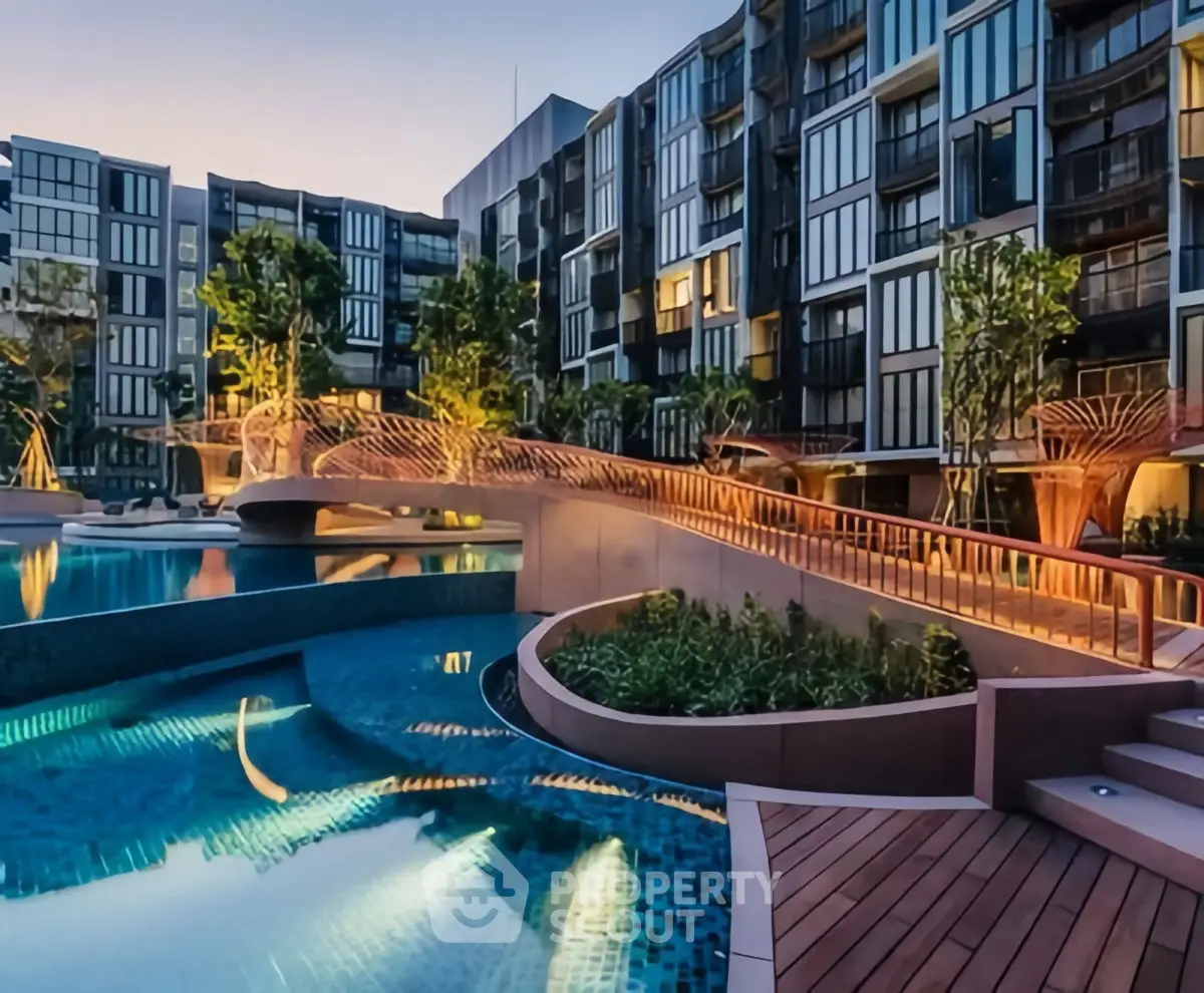 Luxurious modern apartment complex with stunning pool and landscaped gardens.