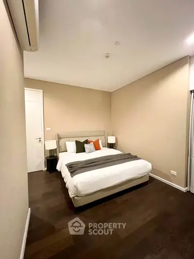 Modern bedroom with cozy bed and stylish decor in a contemporary apartment.