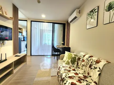 Cozy living room with modern decor and open layout, featuring a comfortable sofa and wall-mounted TV.