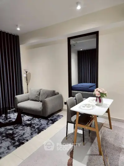 Modern living room with cozy sofa, dining table, and elegant decor in a stylish apartment.