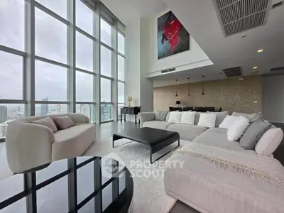 Luxurious high-rise living room with floor-to-ceiling windows and stunning city views.