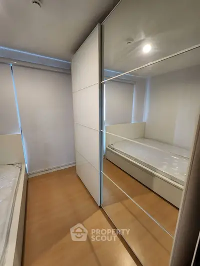 Modern bedroom with mirrored wardrobe and sleek design