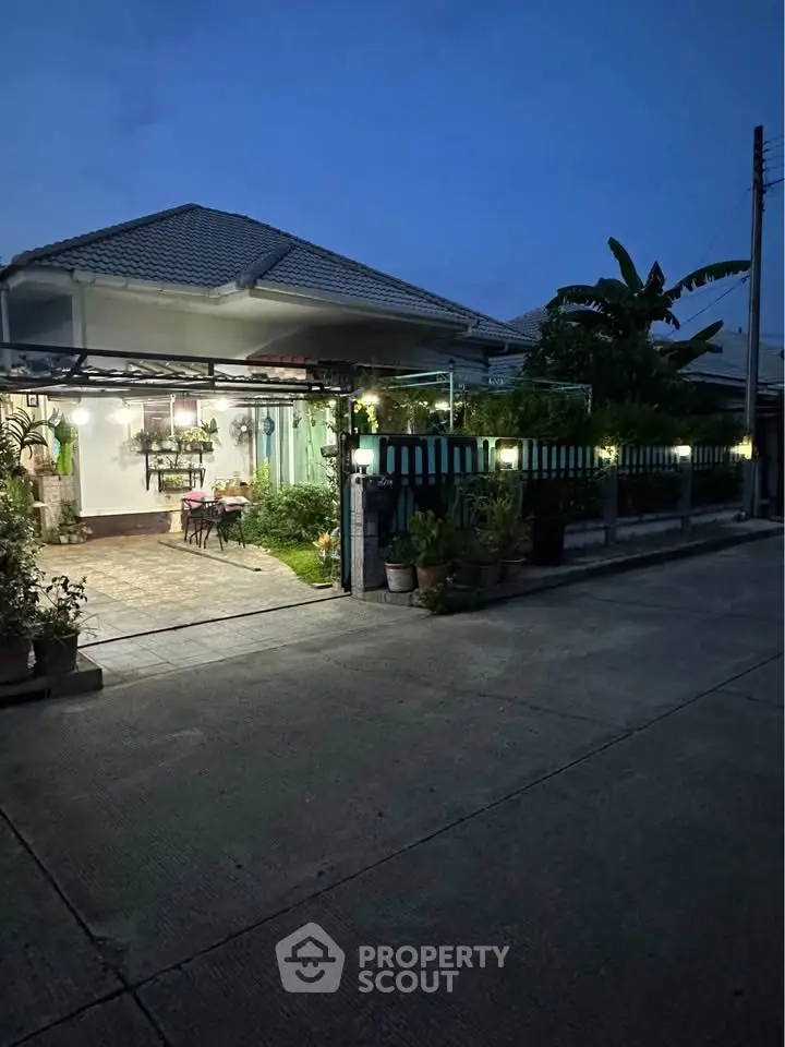 Charming suburban home with lush garden and inviting entrance at dusk, perfect for tranquil living.