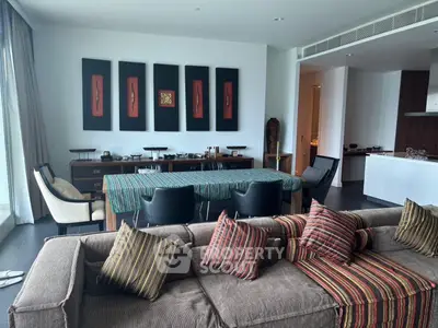 Spacious living room with modern decor and open layout, featuring stylish furniture and elegant wall art.