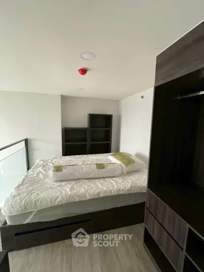 Modern bedroom with sleek design and built-in storage solutions.