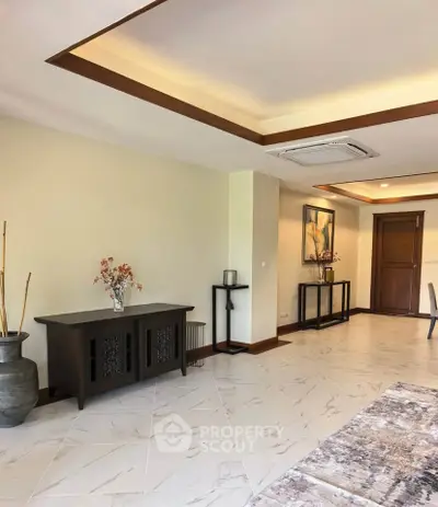 Spacious living room with elegant decor and modern ceiling design