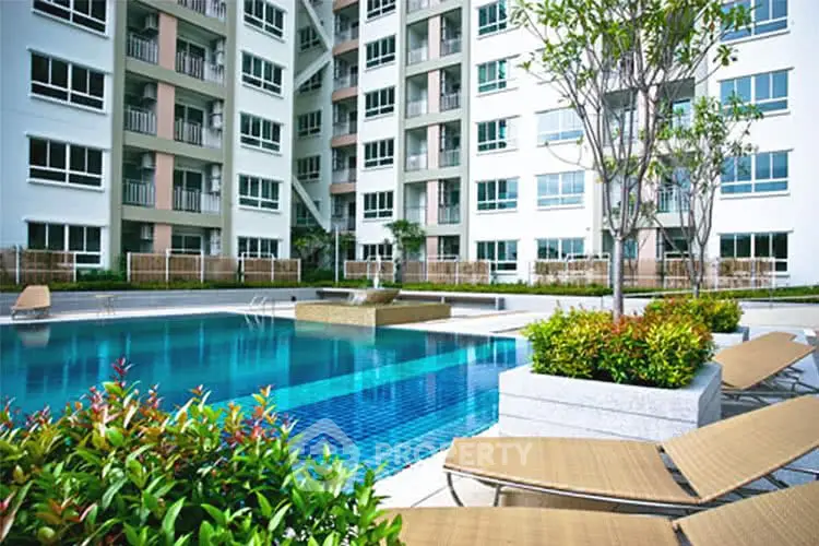 Modern apartment complex with inviting pool and lush landscaping