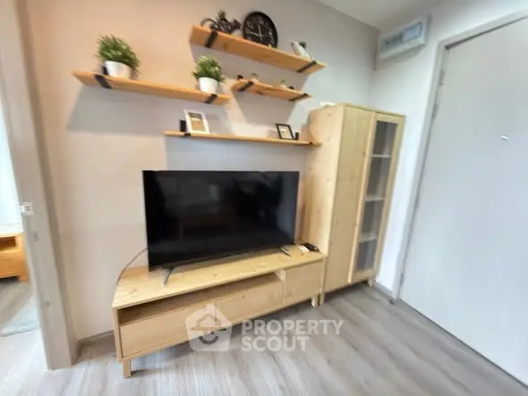 Modern living room with sleek wooden furniture and mounted shelves, perfect for cozy urban living.