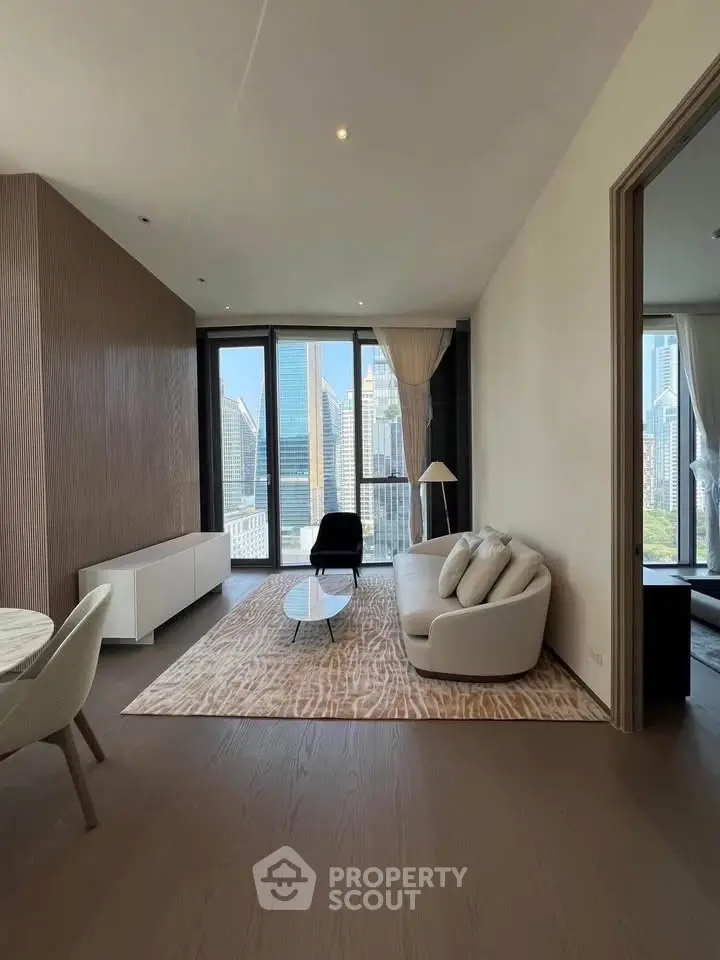 Luxurious living room with stunning city view, modern furniture, and elegant decor in high-rise apartment.