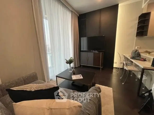 Modern living room with sleek furniture and large window for natural light.