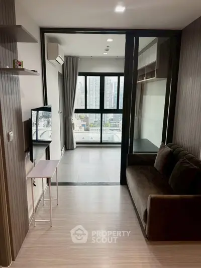 Modern living room with city view, featuring sleek design and large windows for natural light.