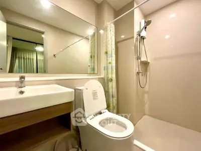 Modern bathroom with shower and sleek fixtures in a contemporary apartment.