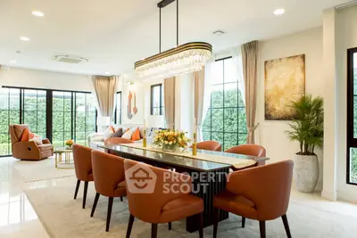 Luxurious open-plan living and dining area with elegant decor and large windows.