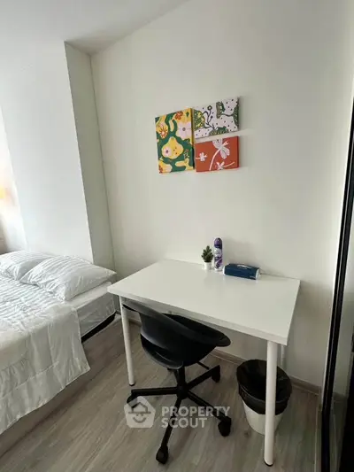 Cozy bedroom with study desk and modern decor, perfect for a comfortable living space.