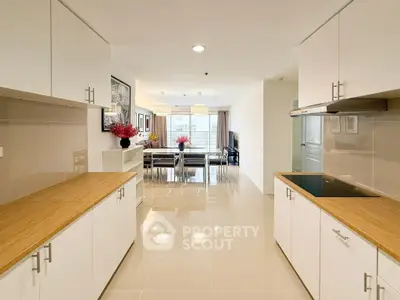 Spacious modern kitchen with open layout and sleek white cabinetry