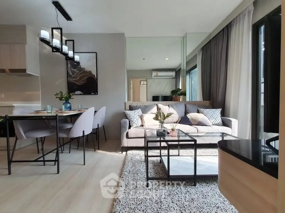 Modern living room with stylish decor and dining area in open layout apartment.