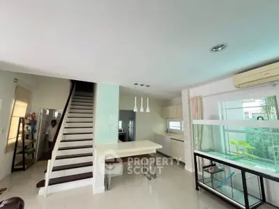 Spacious modern kitchen with open layout and sleek staircase design