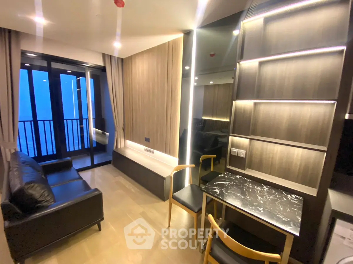 Modern living room with sleek furniture and balcony view