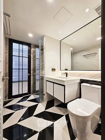 Luxurious modern bathroom with geometric floor tiles and sleek fixtures