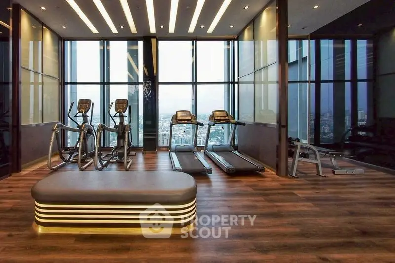 Luxurious high-rise gym with panoramic city views and modern fitness equipment.