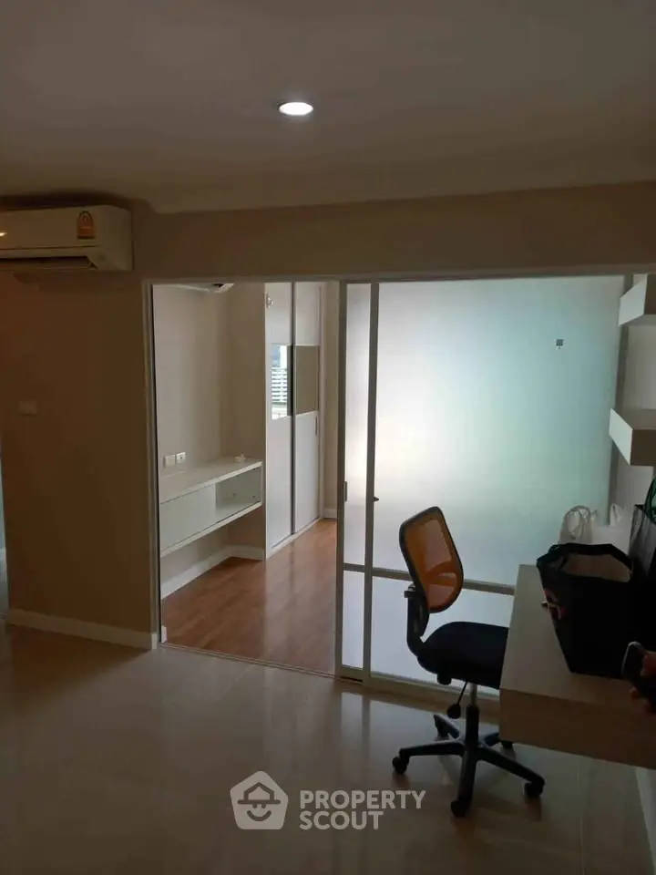 Modern apartment interior with study area and sliding glass doors