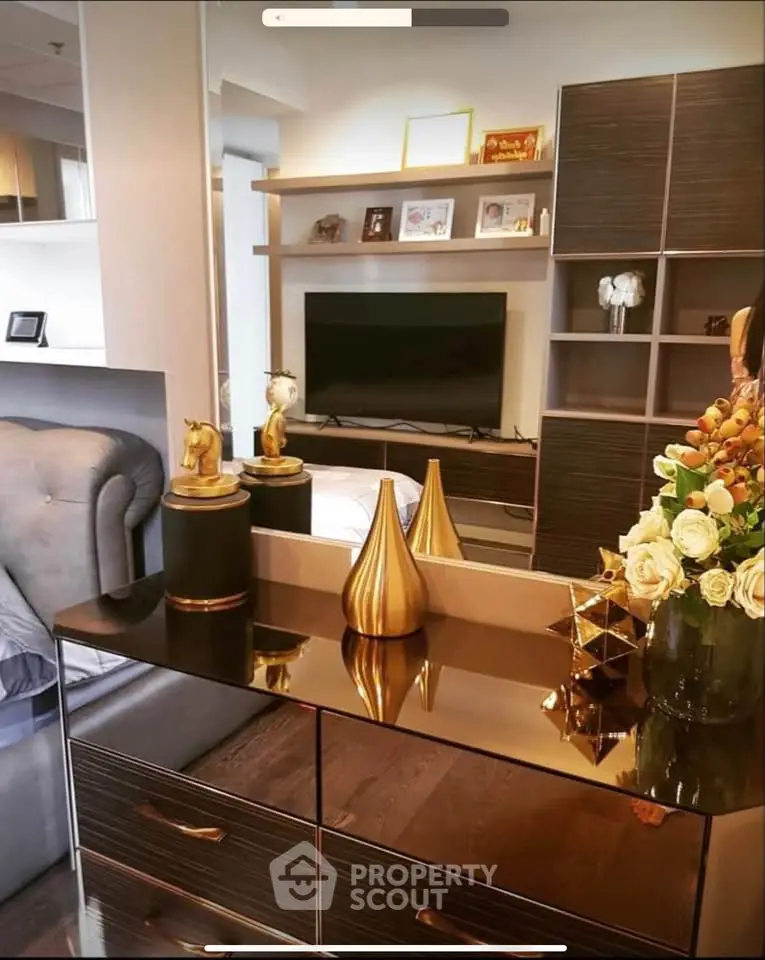 Luxurious living room with elegant decor and modern entertainment center.