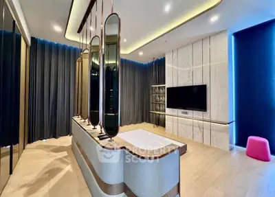 Luxurious modern living room with elegant decor and large TV setup