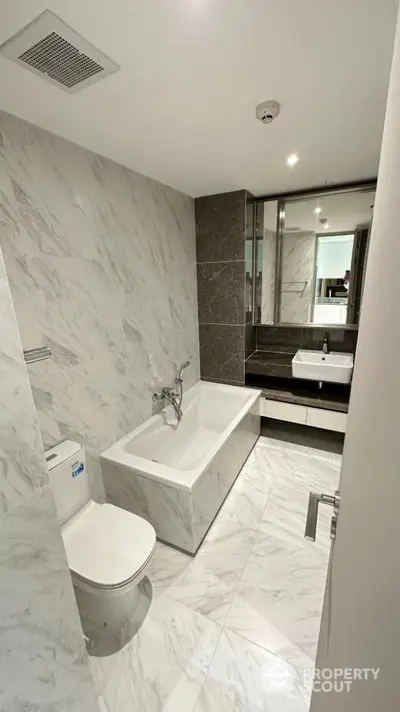 Luxurious modern bathroom with marble tiles and elegant fixtures