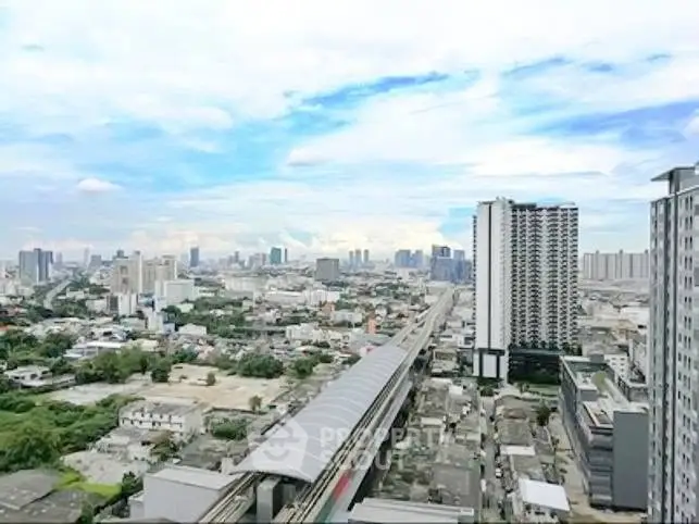 Stunning cityscape view from high-rise building with clear blue sky and urban skyline.
